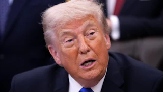 Donald Trump talks while sitting and looking tired