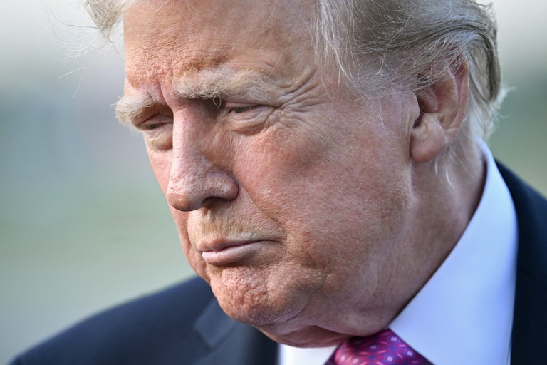 Donald Trump frowns and looks down