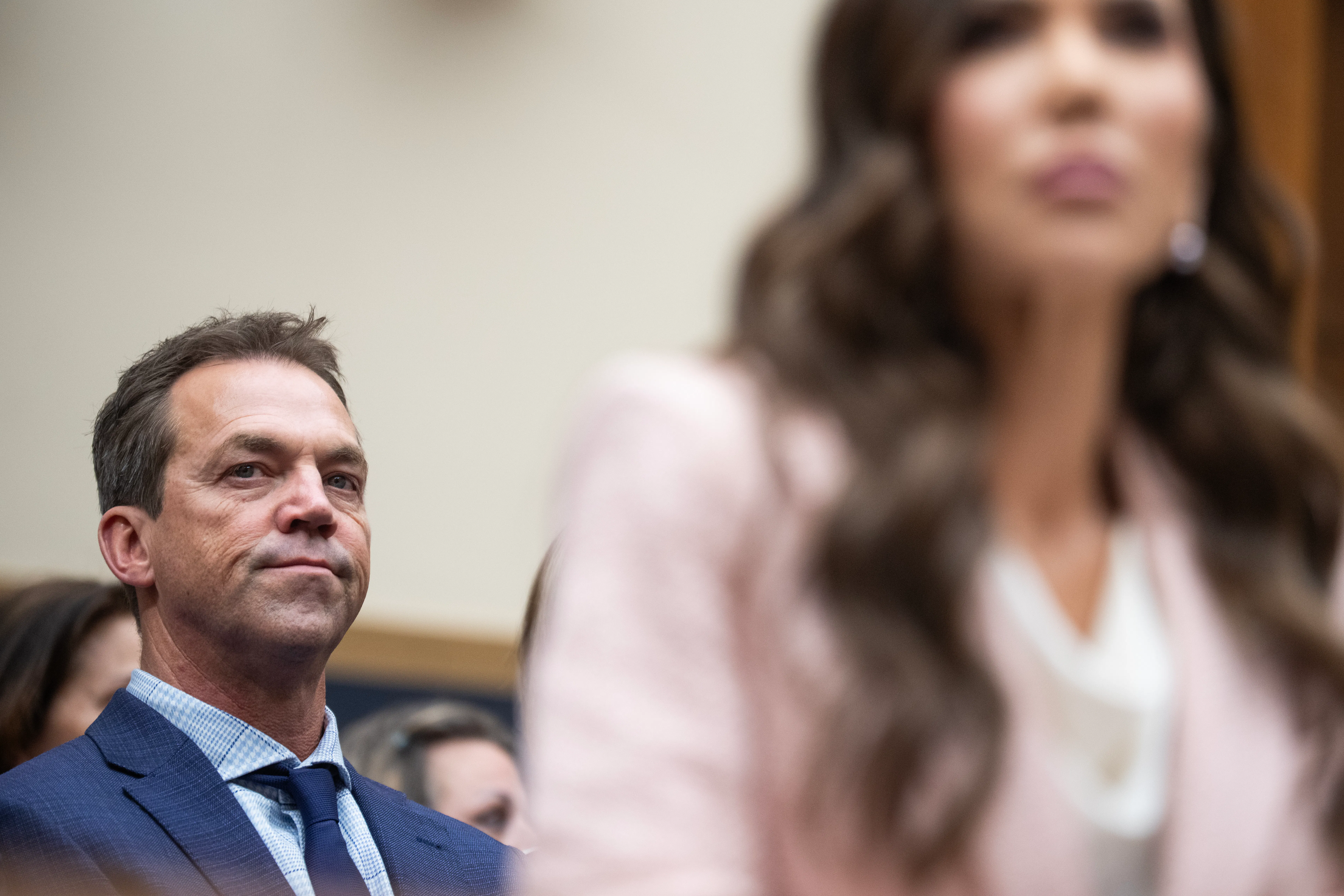 Bryon Noem listens to then-DHS Secretary Kristi Noem as she testifies in Congress.