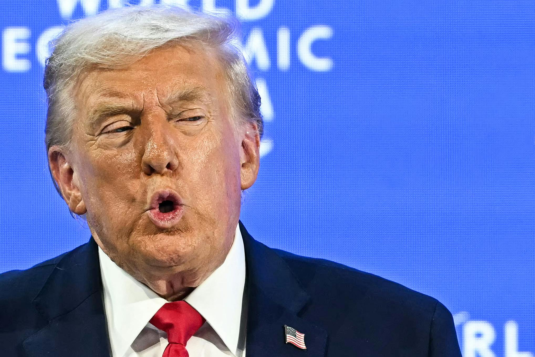 Donald Trump puckers his lips while speaking during the World Economic Forum in Davos
