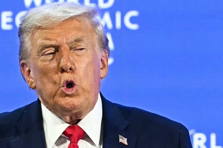 Donald Trump puckers his lips while speaking during the World Economic Forum in Davos