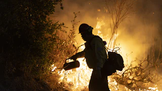 Firefighter attempts to put out a fire