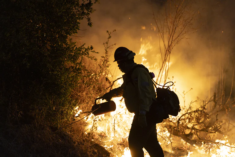 Firefighter attempts to put out a fire