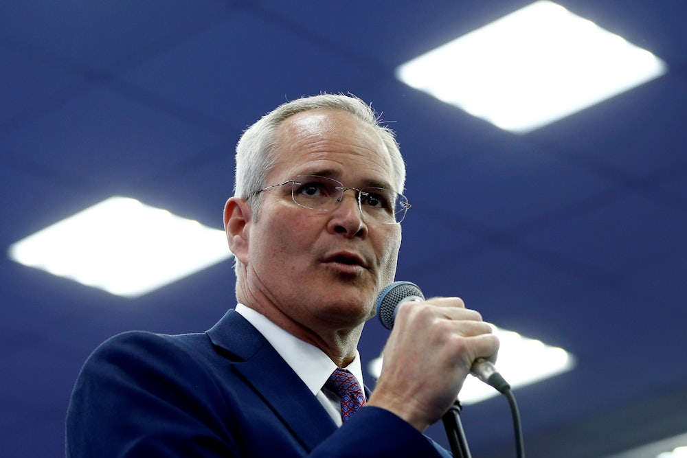 Darren Woods speaks into a microphone.