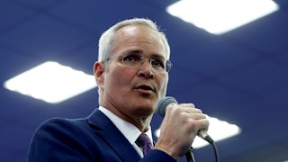 Darren Woods speaks into a microphone.