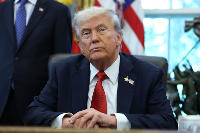 Donald Trump sits at his desk on the Oval Office of the White House.