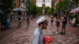 People walk along Church street in Burlington, Vermont