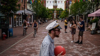 People walk along Church street in Burlington, Vermont