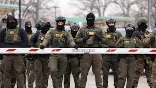 Nearly a dozen masked Border Patrol agents wearing camo