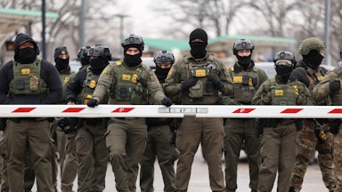 Nearly a dozen masked Border Patrol agents wearing camo