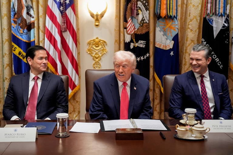 Donald Trump smiles, as do Marco Rubio and Pete Hegseth, sitting on both side sof him in a Cabinet meeting.