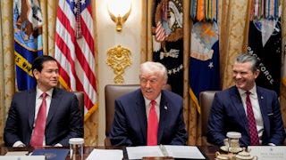 Donald Trump smiles, as do Marco Rubio and Pete Hegseth, sitting on both side sof him in a Cabinet meeting.