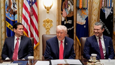 Donald Trump smiles, as do Marco Rubio and Pete Hegseth, sitting on both side sof him in a Cabinet meeting.