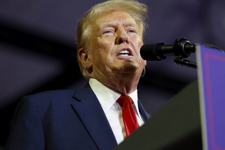 Donald Trump speaking at a lectern