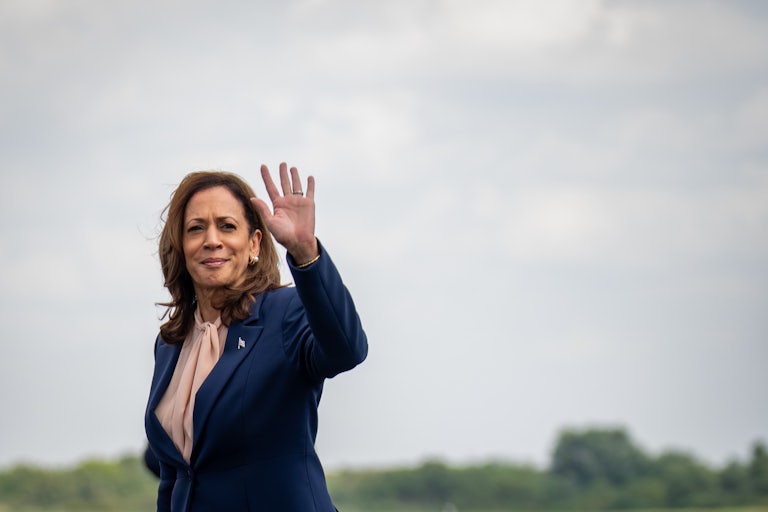 Kamala Harris waves to the camera as she walks outside