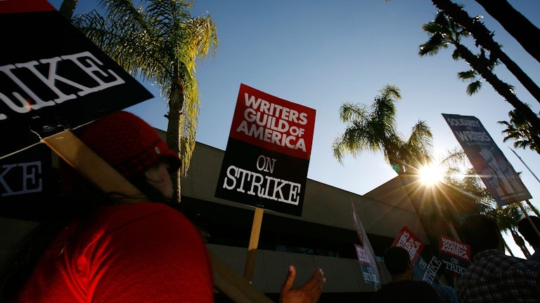 A sign reads Writers Guild of America On Strike!