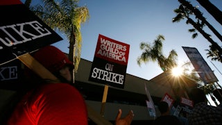 A sign reads Writers Guild of America On Strike!