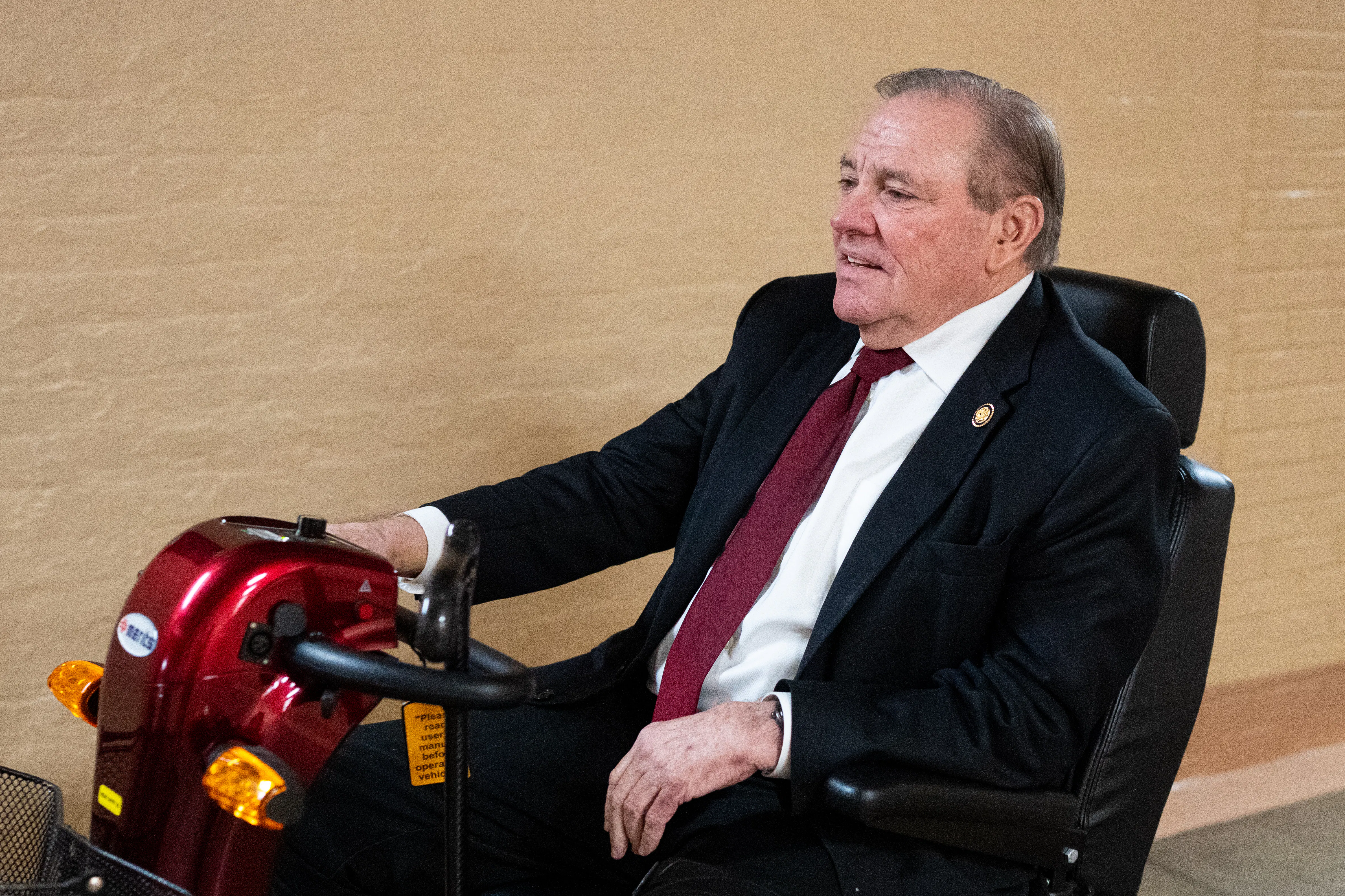 Representative Neal Dunn rides a mobility scooter in the Capitol