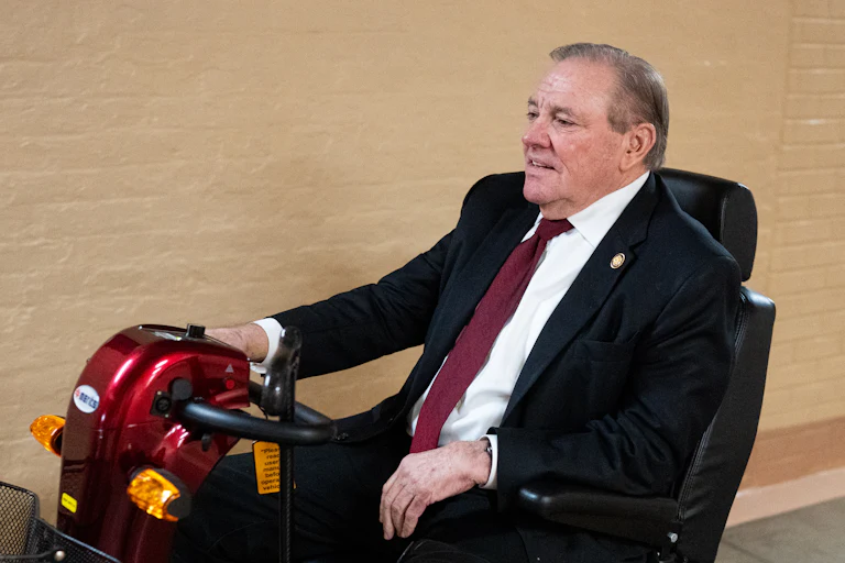 Representative Neal Dunn rides a mobility scooter in the Capitol