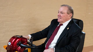Representative Neal Dunn rides a mobility scooter in the Capitol