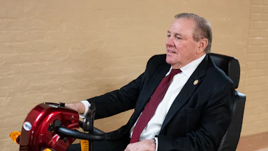 Representative Neal Dunn rides a mobility scooter in the Capitol