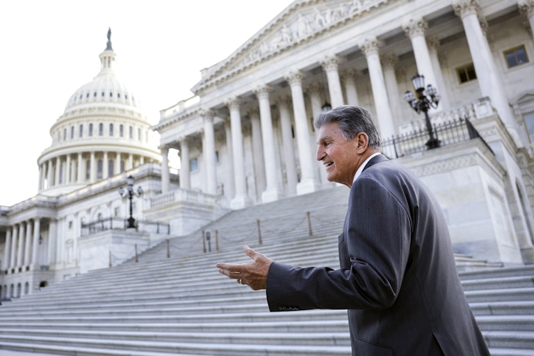 Senator Joe Manchin gestures on the Capitol steps.