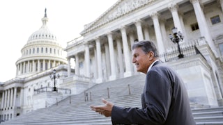 Senator Joe Manchin gestures on the Capitol steps.