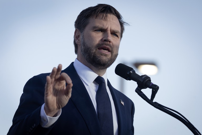 JD Vance speaking at a mic outdoors