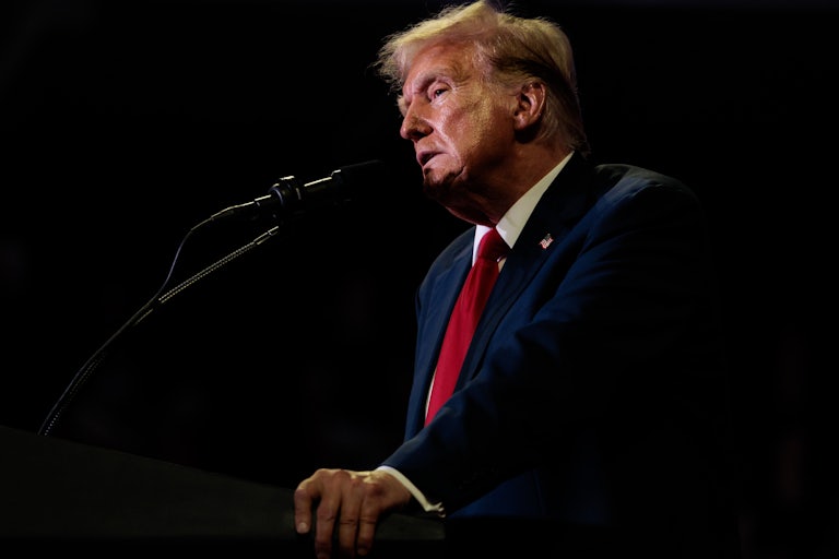 Donald Trump speaks at a mic (profile shot)