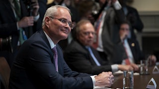 Exxon Mobil CEO Darren Woods appears seated during a meeting at the White House in April.