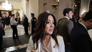 Lori Chavez-DeRemer holds onto her purse as she stands in the Capitol.