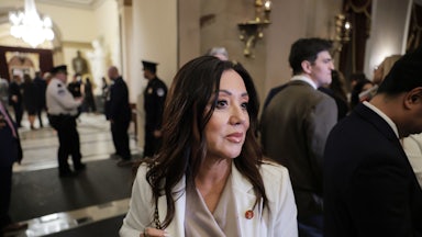 Lori Chavez-DeRemer holds onto her purse as she stands in the Capitol.