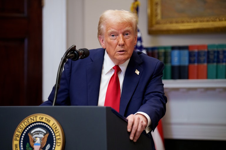 Donald Trump stands at the presidential podium in the White House