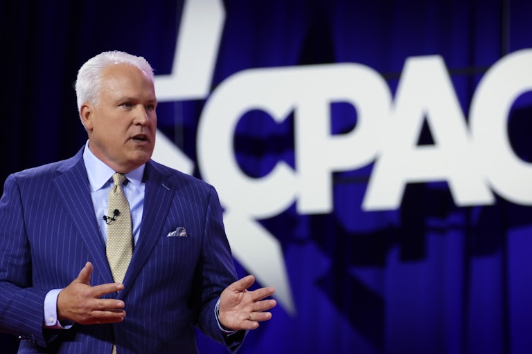 Matt Schlapp stands in front of a huge CPAC logo