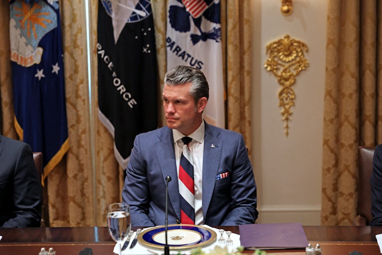 Defense Secretary Pete Hegseth sits at a formal place setting during a lunch meeting between Donald Trump and Ukrainian President Volodymyr Zelenskiy