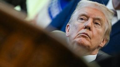Donald Trump sits at his desk in the Oval Office