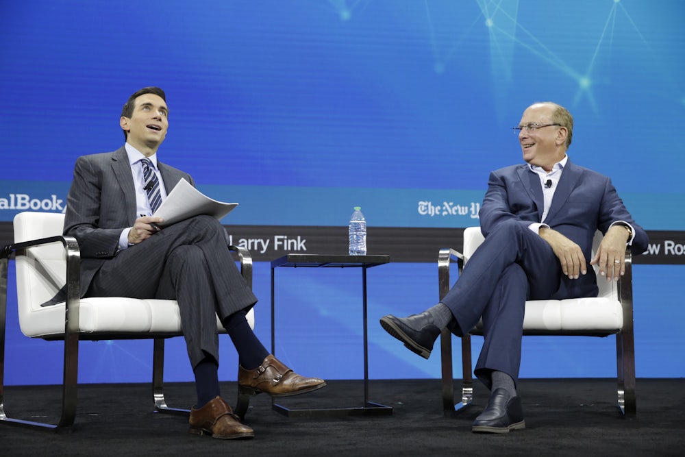 Andrew Ross Sorkin and Larry Fink smile, seated.