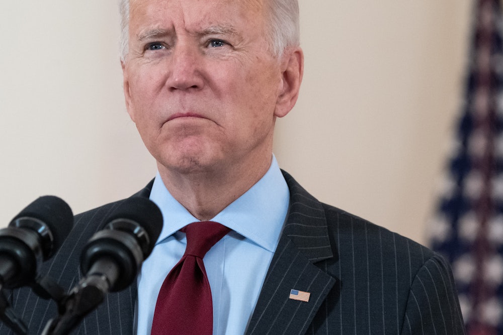 Biden speaks in front of a microphone