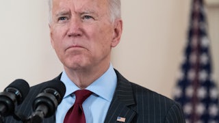 Biden speaks in front of a microphone