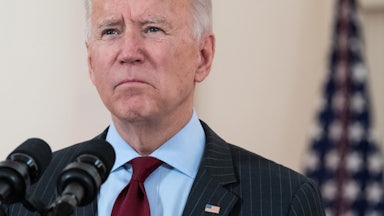 Biden speaks in front of a microphone