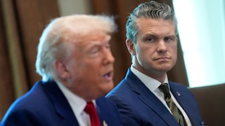 Defense Secretary Pete Hegseth watches as Donald Trump, seated beside him in the White House, speaks.