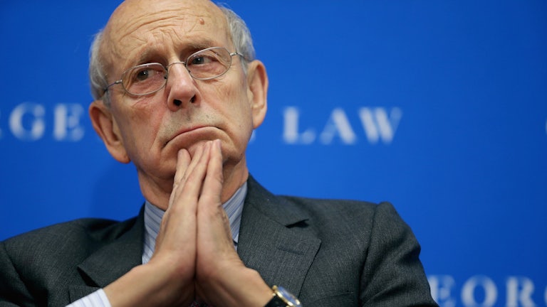 A close-up of Justice Stephen Breyer as he contemplates his next thoughts at a discussion.