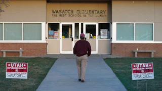 A voter walks into one of the Republican Caucasus at Wasatch Elementary school.