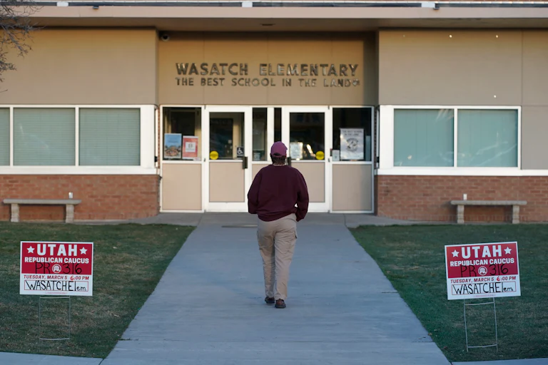 A voter walks into one of the Republican Caucasus at Wasatch Elementary school.