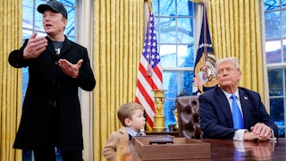 Elon Musk, accompanied by President Donald Trump, and his son X Musk, speaks during an executive order signing in the Oval Office at the White House.