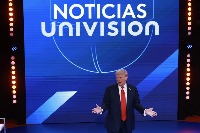 Donald Trump holds his arms out while speaking during a town hall hosted by Univision
