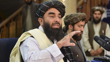 Taliban spokesperson Zabihullah Mujahid gestures with his hands as he speaks during a press conference in Kabul.