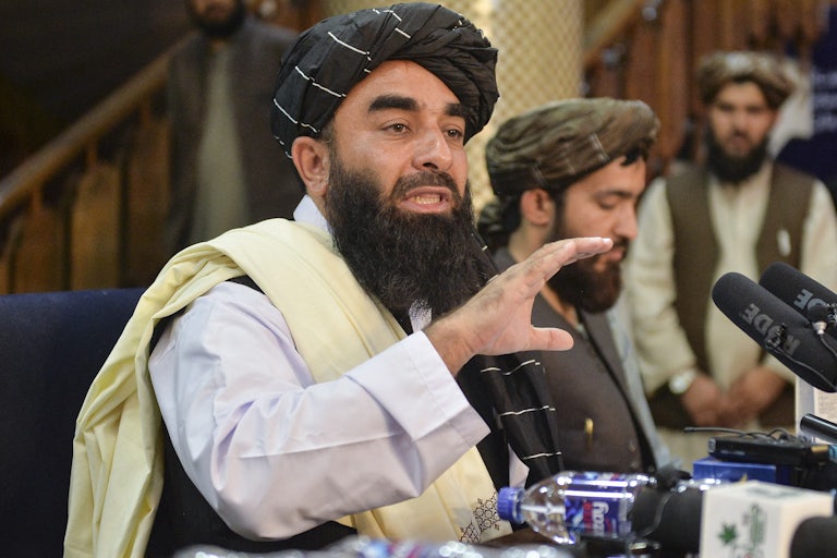 Taliban spokesperson Zabihullah Mujahid gestures with his hands as he speaks during a press conference in Kabul.