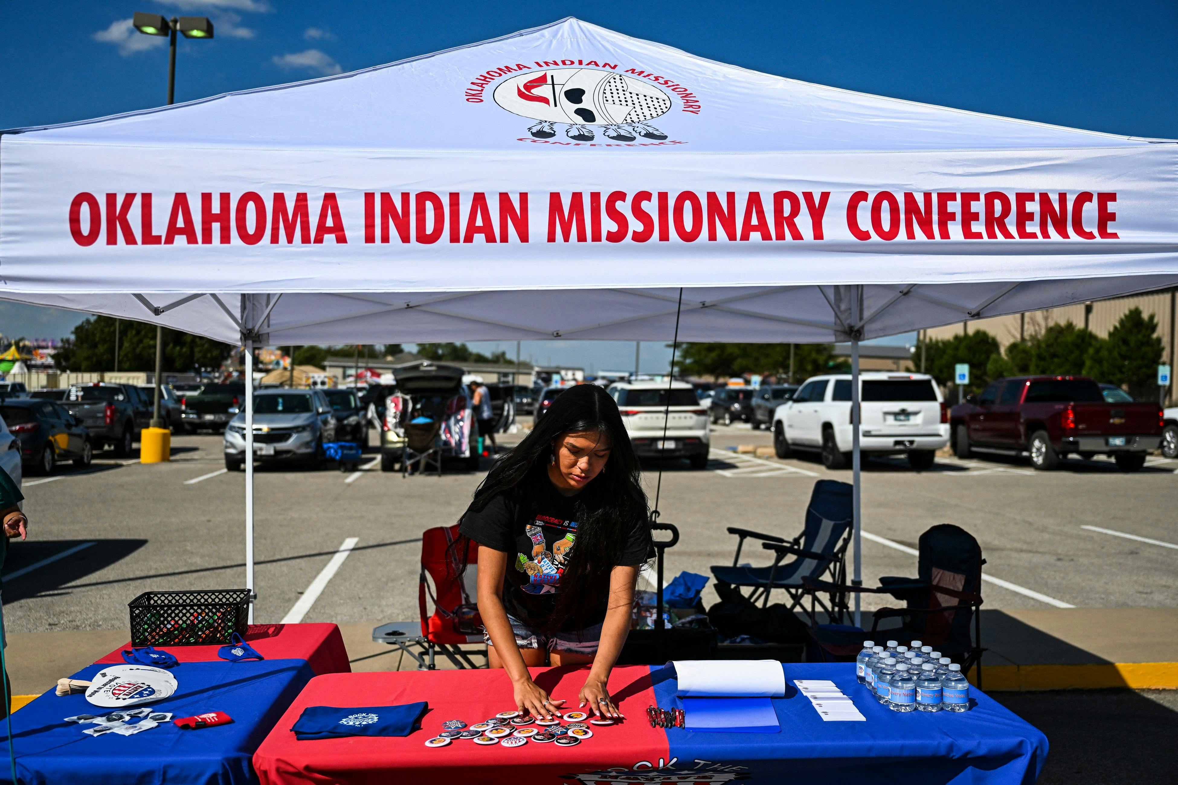 Codie Horse-Topetchy, coordinator of Rock the Native Vote, arranges her stall during a cultural meeting at the Comanche Nation fairgrounds in Lawton, Oklahoma. 