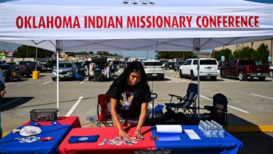 Codie Horse-Topetchy, coordinator of Rock the Native Vote, arranges her stall during a cultural meeting at the Comanche Nation fairgrounds in Lawton, Oklahoma.